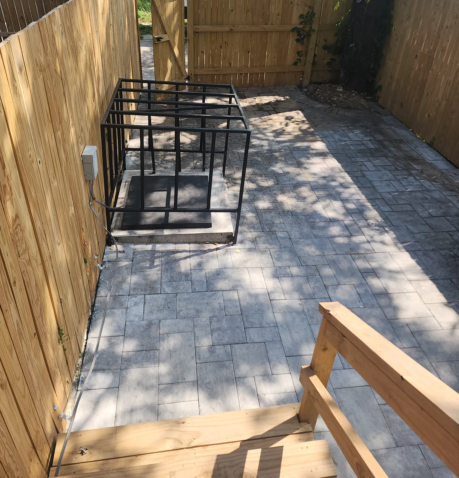 Backyard with new wood privacy fence and gate, paver patio, and wood steps