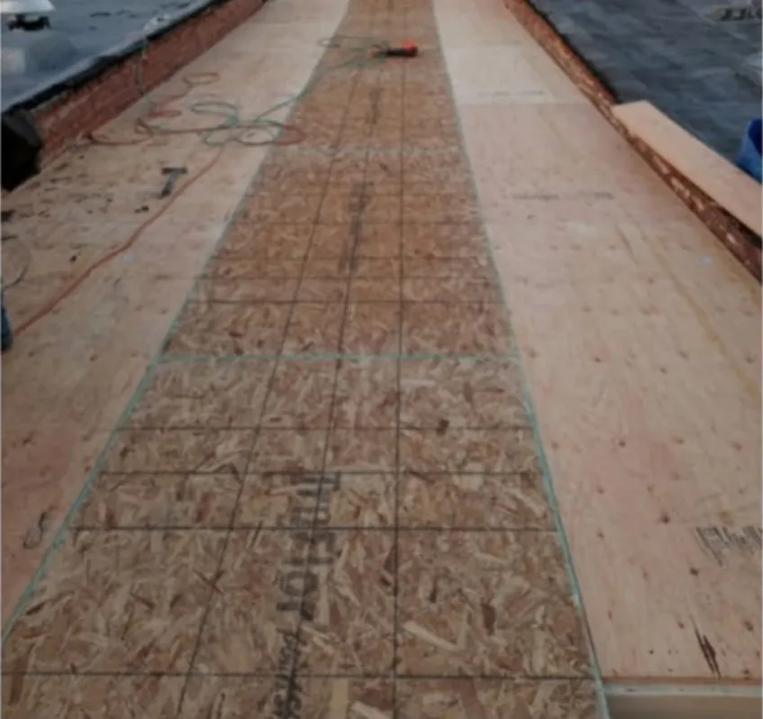 New plywood and OSB roof decking fastened over the new joists